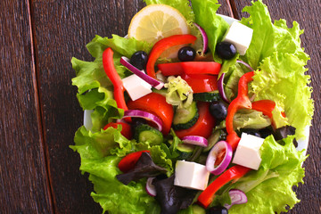 salad from fresh vegetables in a plate on a table, selective focus