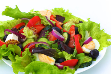 salad from fresh vegetables in a plate on a table, selective focus