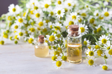 Camomile essential oil and camomile flowers