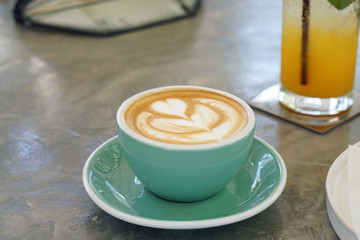 Closeup a cup of hot coffee with milk and latte art on concrete table background, Morning Breakfast.