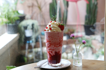 Strawberry Cheesecake Smoothie with strawberry sauce and topped with whipped cream, pomegranate seed, fresh strawberry and rosemary, It's thick and frosty for one tasty treat and refreshing.