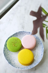 Colorful macarons cake french dessert (not to be confused with Macaroon), It's a sweet meringue-based confection made with egg white, icing sugar, granulated sugar, ground almond, and food coloring.  