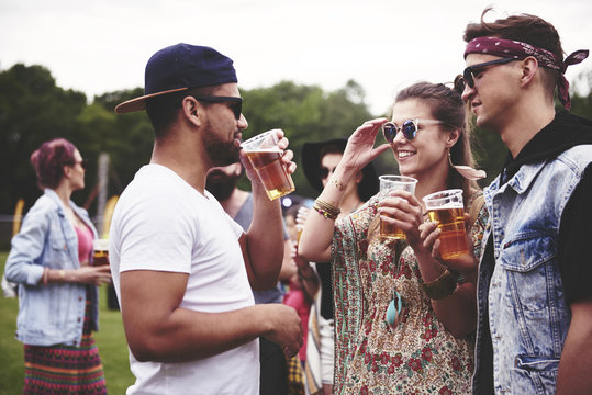 Group of friends drinking beer at the festival