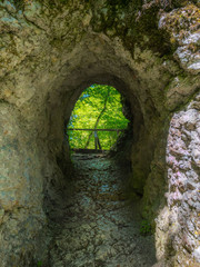 Walk trail with a rock tunnel at Teufelsbrücke near Inzighofen, Upper Danube Nature Park, Sigmaringen district, Baden-Wuerttemberg, Germany, Europe