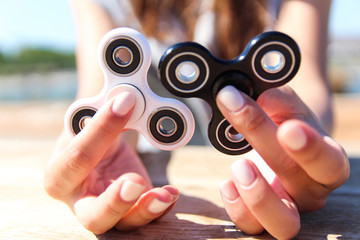 Women hand hold a white and black spinner