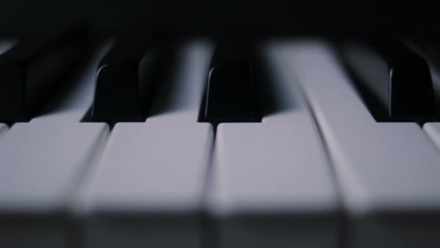 Piano keys on a dark background in motion