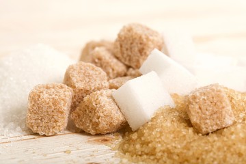 brown and white sugar on wooden background