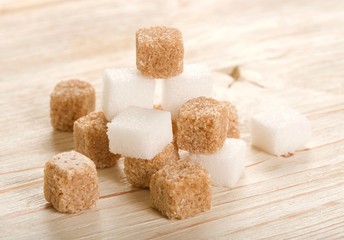 brown and white sugar on wooden background