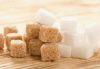 brown and white sugar on wooden background