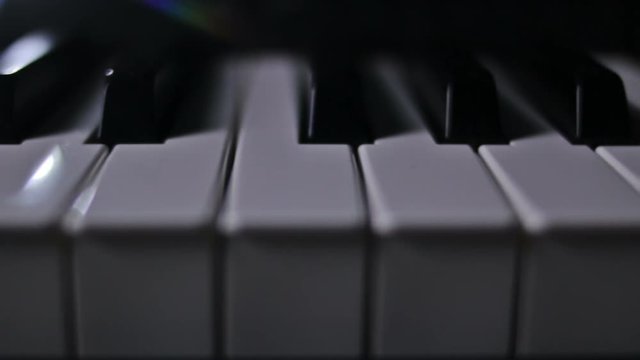 Piano keys on a dark background in motion