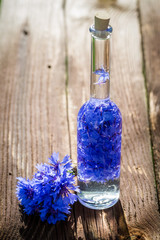 Closeup of homemade healthy tincture of cornflowers