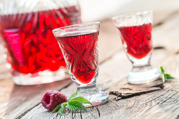 Fresh liqueur with alcohol and raspberries in summer