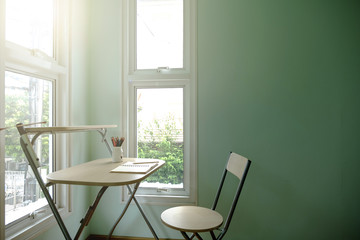 reading writing drawing thinking working with a note book in the morning room with sunshine