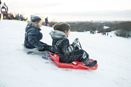 Girls riding sleds