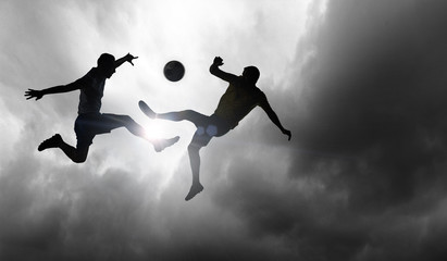 Fototapeta na wymiar Silhouettes of two soccer players