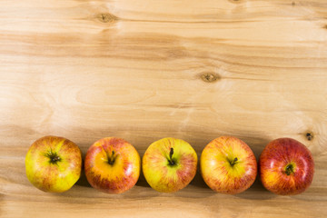 Naklejka na ściany i meble Red apples on a wooden table.