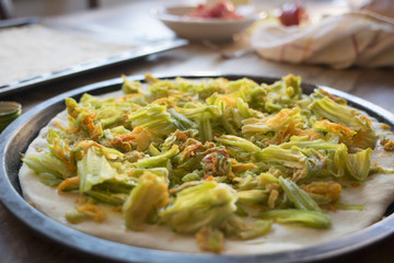 making pizza with zucchini flowers
