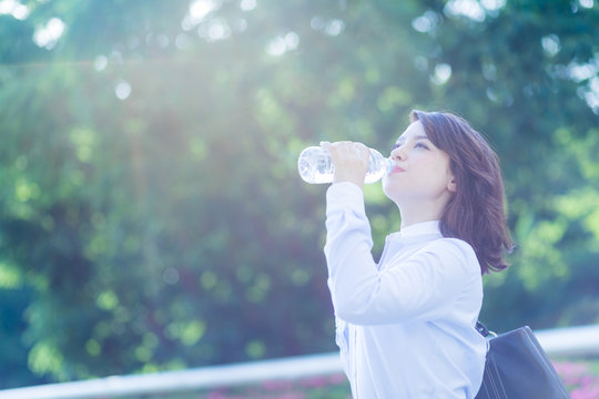 hydration concept. a young woman drinking a bottle of water.