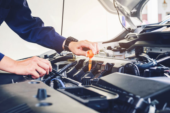Mechanic changing oil mechanic in auto repair service.