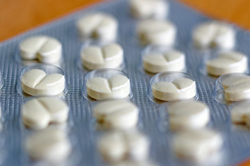 Tablets in a blister pack on the table closeup