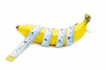 Measuring tape wrapped around a banana, isolated on a white background