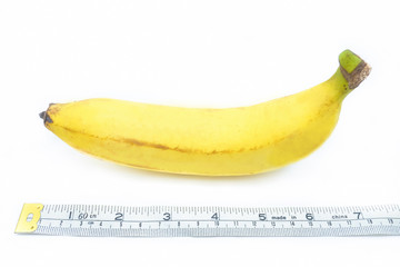 Measuring tape wrapped around a banana, isolated on a white background