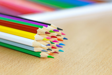 Color pencils on a wooden table closeup