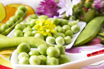 Spoon with green peas