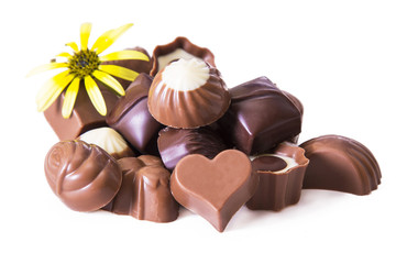 Obraz na płótnie Canvas assortment of chocolates with flower isolated on white