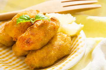 croquettes filled with meat with wooden cutlery.