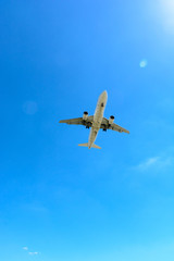 View from below of a flying airliner in landing approach or taking off.