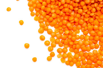 Red lentils on a white background