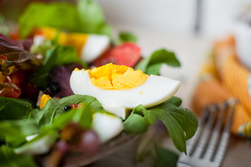 Fresh vegetable salad and freshly squeezed mango juice. Salad from arugula, black and red caviar, tomato, eggs, goat cheese, olive oil. Smoothies of mango, carrot, pumpkin. Vitamins, vegetarianism