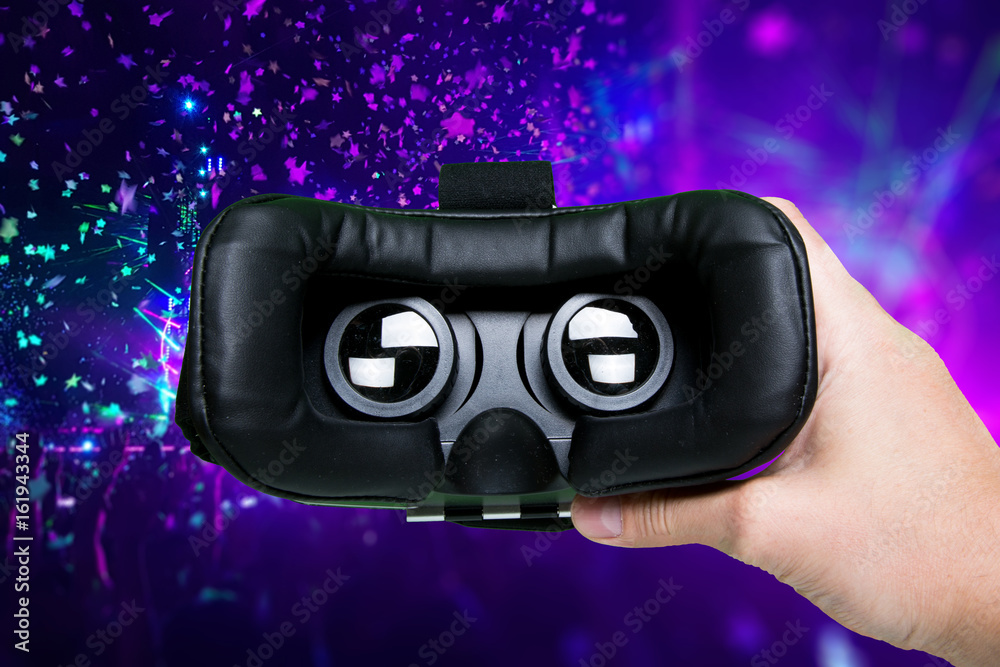 Wall mural man hand holding vr glasses on colorful background.top view/hands of man holding virtual reality gog