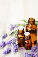 Fototapeta na wymiar Lavender essential oil in the amber bottle, with fresh lavender flower heads.