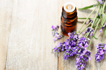 Lavender essential oil in the amber bottle, with fresh lavender flower heads.