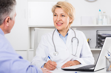 Doctor listens to mature patient