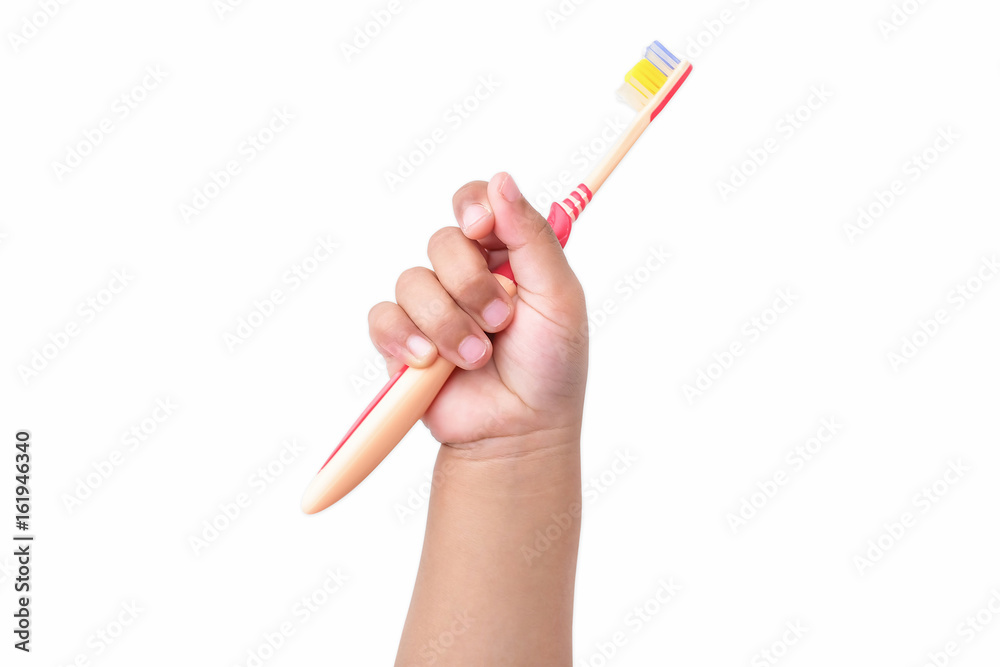 Poster child's hand holding a toothbrush, isolated on a white background