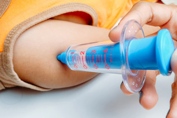 children and syringe toy, isolated on a white background