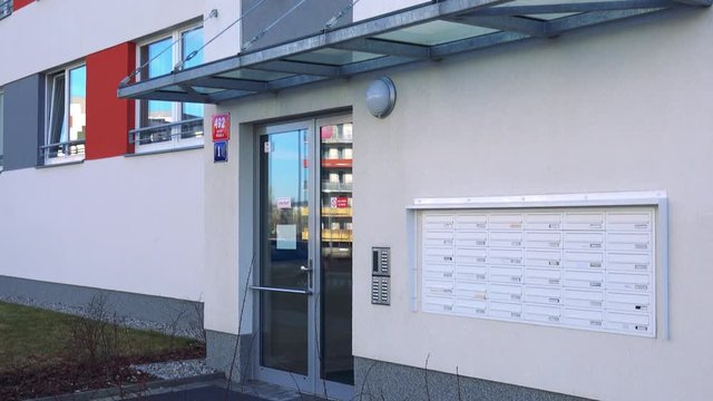 entrance to the modern high-rise block of flats with mailboxes