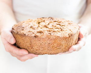 freshly baked bread in male hands.