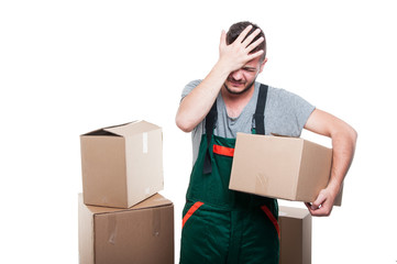 Mover man holding cardboard box gesturing mistake