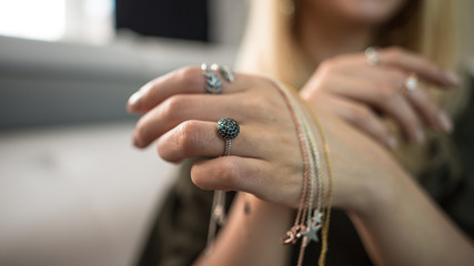 Woman showcasing jewelry on her hands