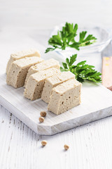 Tofu with fresh coriander on white background.