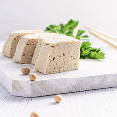Fototapeta na wymiar Tofu with fresh coriander on white background.