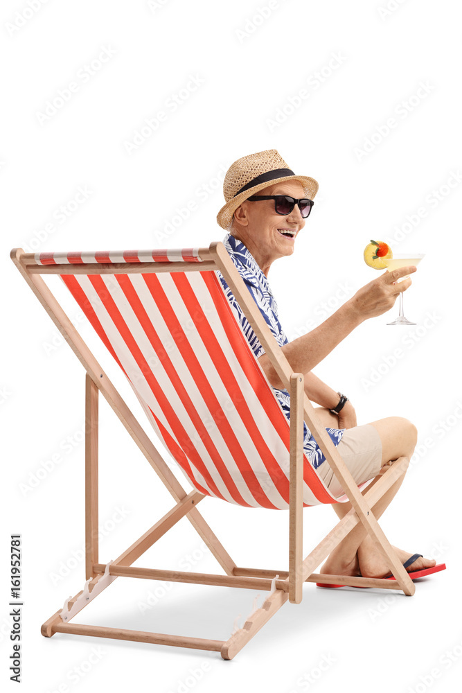 Poster happy elderly tourist with a cocktail sitting in a deck chair