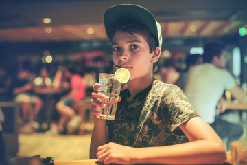 Thirsty boy with fresh drink