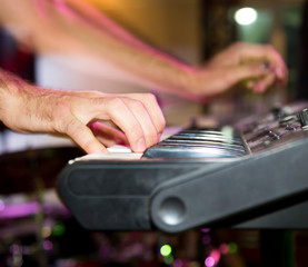 Musician plays keyboards in a rock band