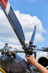 Service three-blade propeller helicopter on a special site.