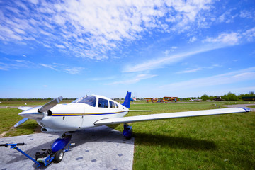 Small aircraft in the parking lot of the airfield.